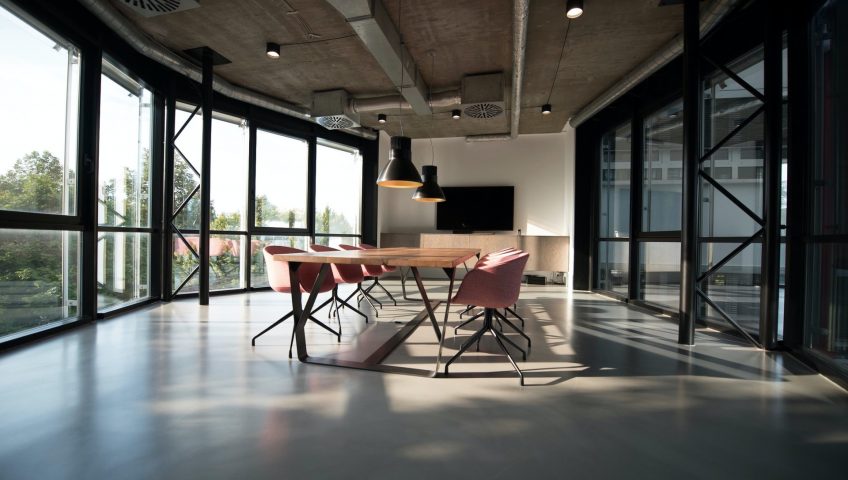 Make your office look spacious for increased workplace efficiency and productivity. Empty conference room with sunlight streaming in from floor to ceiling windows
