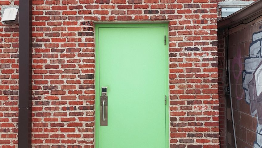 Commercial Steel Doors; a customised steel entrance door in a brick building