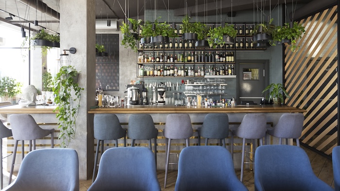 Restaurant design trends, an open layout of a restaurant filled with ample seating and plants